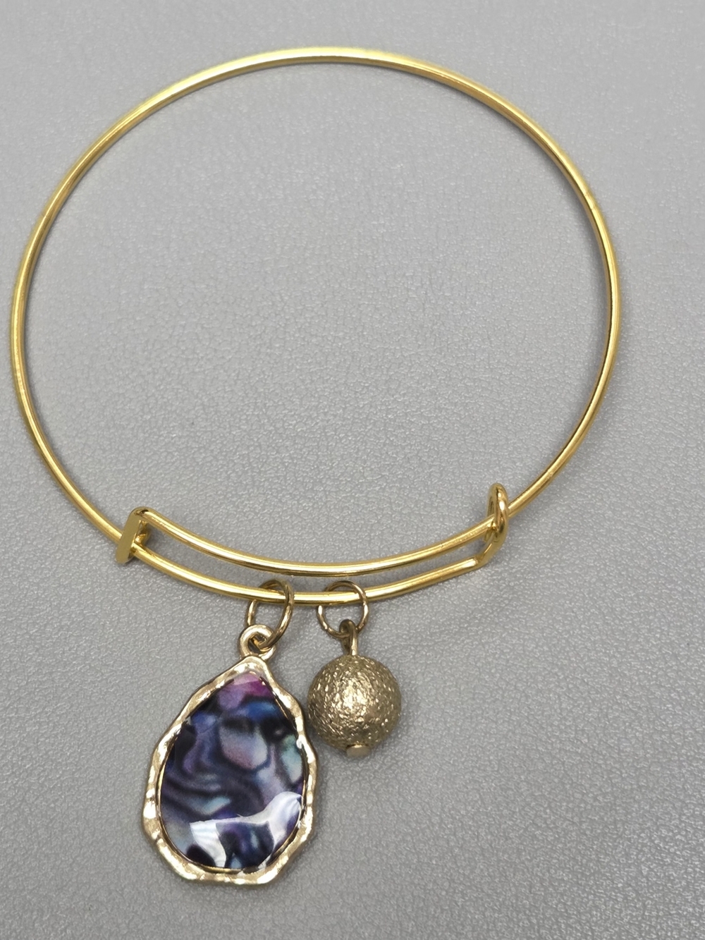 Gold-Tone Bangle Bracelet with Iridescent Abalone Charm